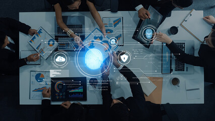 A diverse business team engages in collaboration, focusing on digital security and data analytics. The scene captures the importance of protection in modern operations. Trope