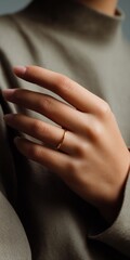 Close-up of female hand with gold ring on finger