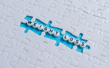 Weight Loss text on light blue background with jigsaw puzzle