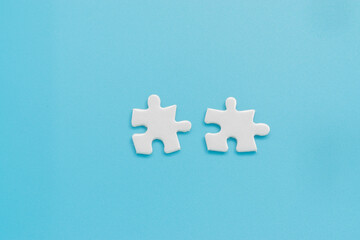 Double jigsaw puzzle on light blue background