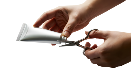 Hands cutting a squeezed tube with scissors isolated on transparent background