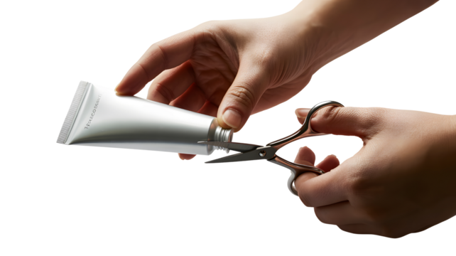 Hands cutting a squeezed tube with scissors isolated on transparent background
