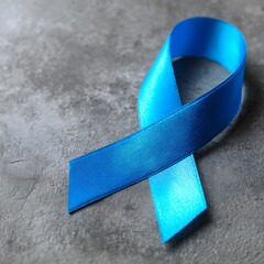 Blue ribbon on a stone surface symbolizing prostate cancer prevention