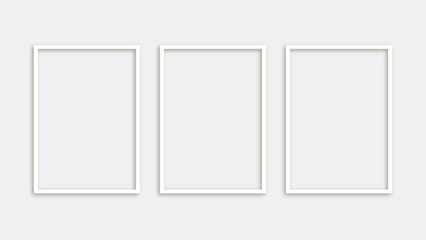 Three blank white photo frames isolated on white background in modern minimalist style for wall decoration and interior design