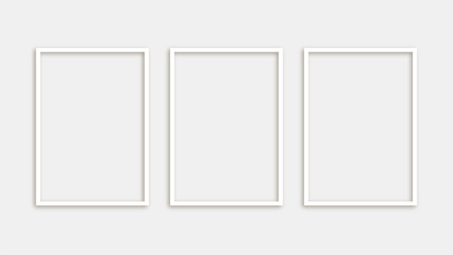 Three blank white photo frames isolated on white background in modern minimalist style for wall decoration and interior design