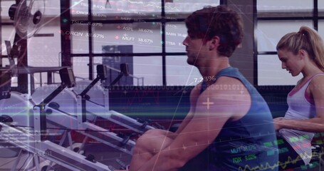 Rowing muscular man wearing blue sleeveless top pulling handle on rower at gym, with charts overlay