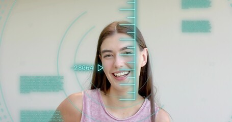 Smiling woman in pink sleeveless top facing camera in studio showing turquoise HUD -28064 overlay