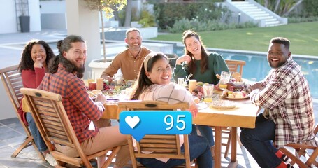Dining six adults wearing casual clothing sitting at patio table, with fruit, pitcher and heart 95