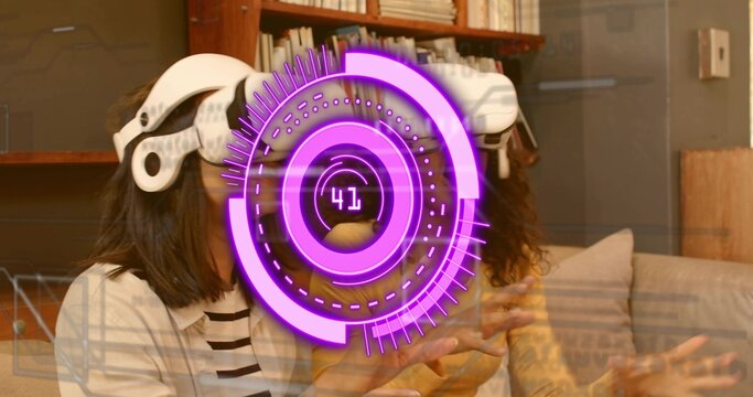 Gesturing two women wearing white VR headsets on couch in living room, displaying purple HUD 41