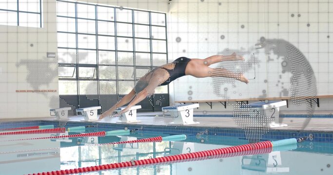Diving mature swimmer in black one-piece swimsuit and cap launching from starting block at pool