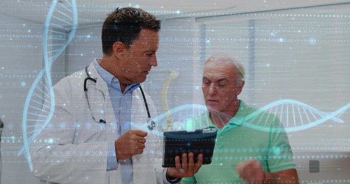 Examining doctor in coat, stethoscope and patient in polo viewing tablet in clinic, DNA graphics