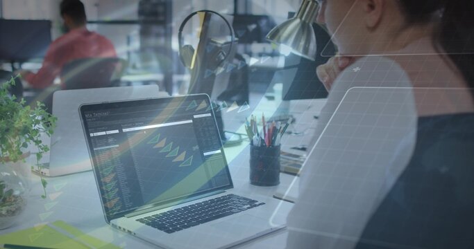 Working woman in dark top focusing on laptop with code dashboard at open-plan office, copy space