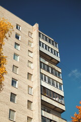 Minimal composition with rusty concrete balconies against bright blue sky, urban decay aesthetic.