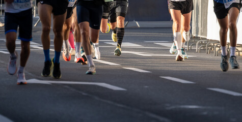 Close up view of diverse marathon runners legs and running shoes outdoors in Ljubljana