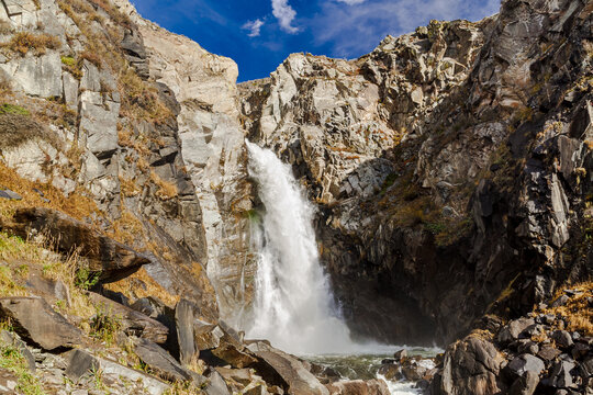 Waterfall Kurkure with rainbow in Altai Mountains territory, West Siberia, Russia.