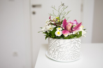 Bouquet of pink and white flowers in decorative box. Copy space. Celebration, tenderness, and natural beauty of floral composition.