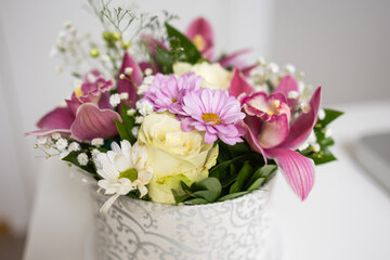 Close-up of mixed flowers with rose and orchid. Gentle textures, harmony and natural elegance in home decor.