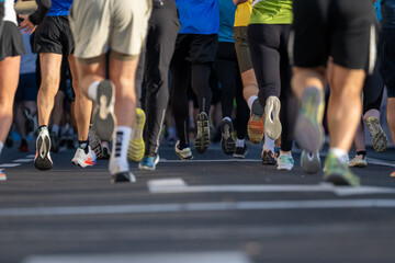 runners competing in a marathon race in Ljubljana with a close up view of legs and feet in motion