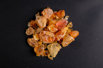Amber resin pieces on black background