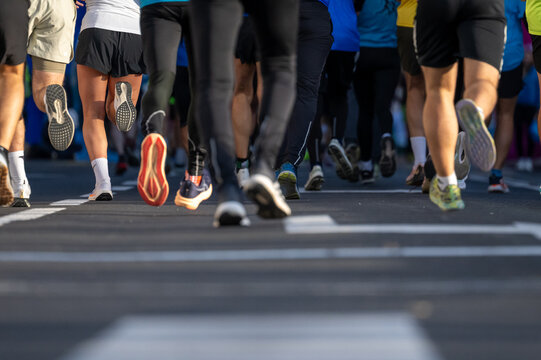 Close up of runners participating in a diverse marathon event outdoors in Ljubljana