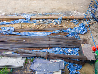 Steel Rebars Stacked at Construction Site for Building Reinforcement.