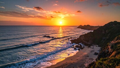 Coastal vista at sunset; golden sun illuminates the sky and reflects on the ocean, waves gently roll towards the shore. Rugged cliffs on the right