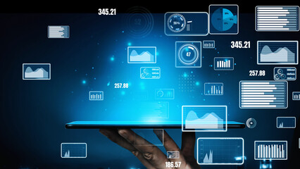 A digital tablet held in hand displays futuristic graphs and charts, representing innovative data visualization concepts for business analytics and technology advancements. Xenic