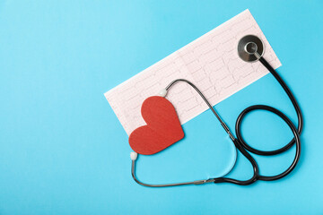 Medical stethoscope, red heart, and cardiogram on a color background. ECG, Heart wave, heart attack, cardiogram report. Cardiogram pulse trace and heart concept. Healthcare.Space for text
