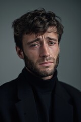 Fototapeta premium Portrait of a thoughtful young caucasian male in black turtleneck