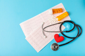 Medical stethoscope, red heart, and cardiogram on a color background. ECG, Heart wave, heart attack, cardiogram report. Cardiogram pulse trace and heart concept. Healthcare.Space for text