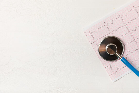 Medical stethoscope, red heart, and cardiogram on a color background. ECG, Heart wave, heart attack, cardiogram report. Cardiogram pulse trace and heart concept. Healthcare.Space for text - Powered by Adobe