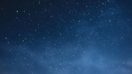 Fototapeta premium An expansive deep blue night sky adorned with thousands of bright twinkling stars creating a serene and magical atmosphere