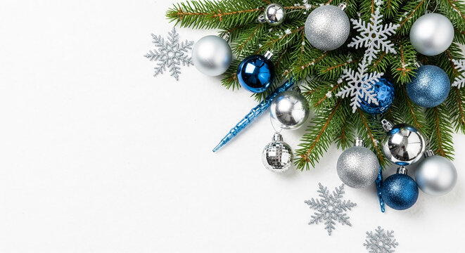 Ornamental pine branch with silver and blue baubles and snowflakes on white, festive background representing holiday cheer and winter celebration - Powered by Adobe