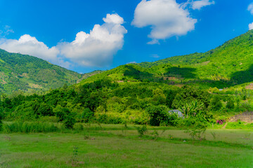 The foot of the hills.

Hills with vegetation near Nha Trang in Vietnam. Cloudy weather.