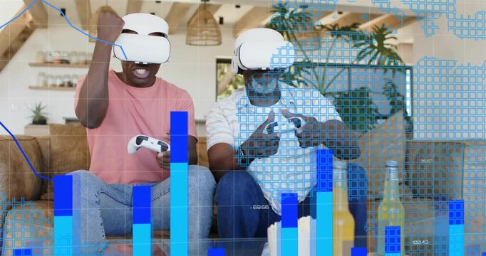 Father and son pressing controllers, causing blue charts and grids overlaying, cheering gaming win