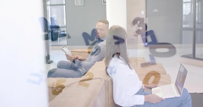 Man looking back checking in, tapping tablet, woman glancing laptop, digits over glass, business