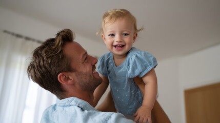 Joyful father lifting his smiling toddler daughter in a cozy indoor setting, enjoying a heartfelt moment together.