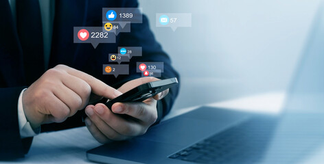 Person using smart phone with emoticon icons of Social Media.Interactive with friends on chat with emoticon feedback.Social media,marketing, like,social network,blog,live,chat reaction and livestream.