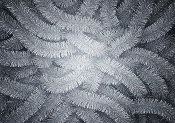 A shimmering, silver background created by dense metallic tinsel strands used for classic festive holiday decoration, closeup, celebration, soft focus