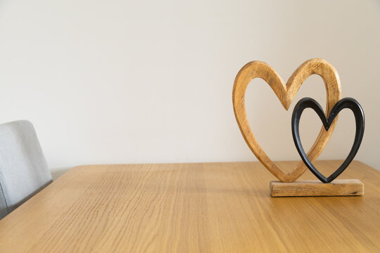 Two hearts on wooden table. Affection, togetherness, and intimate harmony of shared home life. Copy space