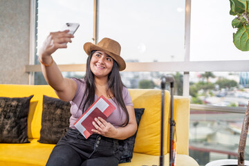 Young woman taking selfie while waiting for flight