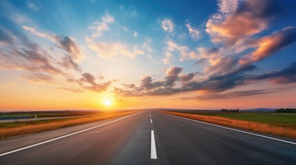 Fototapeta premium Empty road stretching towards a stunning sunset horizon.