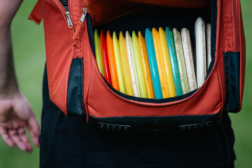 red discgolf bag full of discs