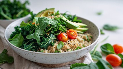Fresh quinoa salad with greens and cherry tomatoes in a simple bowl