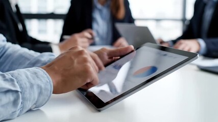 Business professional analyzing financial data and charts on a digital tablet during a corporate meeting showcasing modern technology teamwork and data-driven - Powered by Adobe