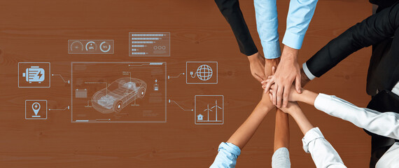 A group of diverse professionals collaborates at a sleek office table, combining hands to symbolize...