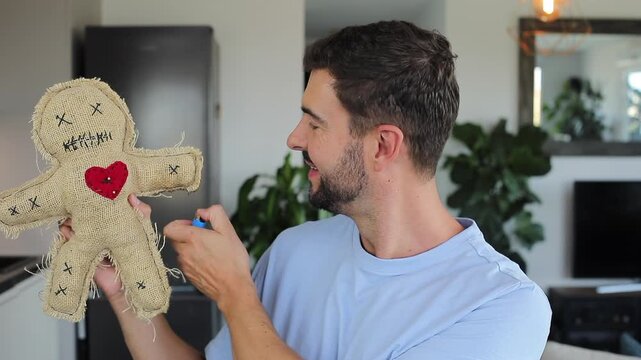 Comedic video of a man with esoteric experience holding traditional voodoo doll during Halloween 