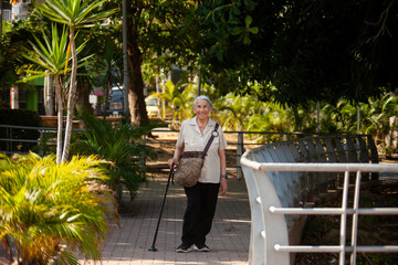 Senior woman at the Ronda del Sinu walking path along the river bank in the city of Monter&iacute;a, Colombia.