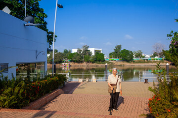 Senior woman at the Ronda del Sinu walking path along the river bank in the city of Monter&iacute;a, Colombia.