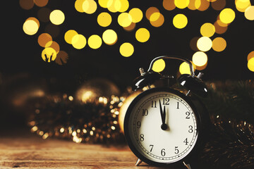 New Year greeting card design with alarm clock and bokeh lights